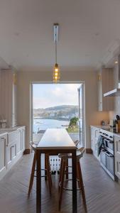 a kitchen with a table and a view of the water at Luxury Waterfront House in Cobh