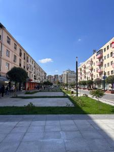 an empty street in a city with tall buildings at The Classic Studio in Buzău