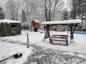 a gazebo in a yard covered in snow at Mini Hotel Zakrut in Tatariv +116 photos