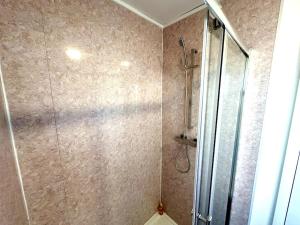 a bathroom with a shower with a glass door at Thorntree Place Blue Skies Stays in Thornaby on Tees