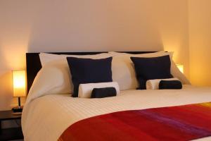 a bedroom with a large bed with two pillows at Modern Double bedroom in city apartment room 2 in London