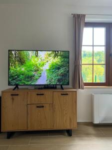 a flat screen tv sitting on top of a wooden entertainment center at Villa Ksilifor in Veliko Tŭrnovo