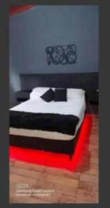 a bed with black and white sheets and pillows at Casa Vip Pileta Climatizada Carlos Paz in Tanti