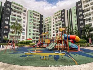 a playground in front of a large building at Crystal Cozy Suite PoolView Netflix Waterpark@ Ipoh Station 18 in Ipoh