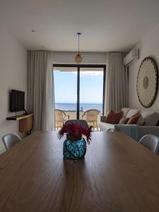 a living room with a wooden table with a vase on it at Seaview serenity apartment in Flic-en-Flac