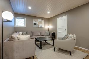 a living room with a couch and two chairs at Luxury Villa Himos Hillside in Himos