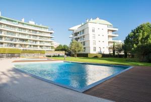 a swimming pool in front of a building at Scala Cascais Top apartment in Cascais
