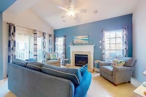 a living room with a couch and a fireplace at Creekside --- 13 Hull Ln in Millville