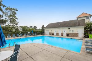 a large swimming pool with chairs and a table at Creekside --- 13 Hull Ln in Millville