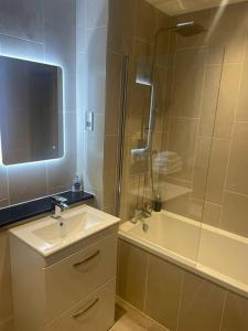 a bathroom with a sink and a shower and a tub at Luxurious 1 Bed - CITY VIEWS in Liverpool