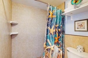 a bathroom with a shower curtain with fishes on it at Daytona Dreamin' Unit 320 in Daytona Beach