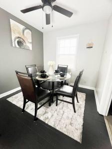 a dining room table with chairs and a ceiling fan at The Gateway: Entire Apartment 7 mins from airport in Cleveland