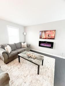 a living room with a couch and a coffee table at The Gateway: Entire Apartment 7 mins from airport in Cleveland