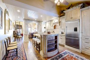 a kitchen with white cabinets and a large island at The Silver Saddle in Ketchum