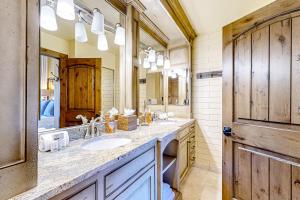 a bathroom with two sinks and a large mirror at The Silver Saddle in Ketchum +38 photos