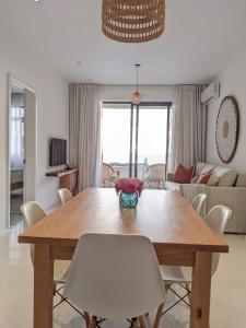 a dining room table and chairs in a living room at Seaview serenity apartment in Flic-en-Flac