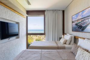 a bedroom with a bed and a large window at Mansão Vista de 180º para Mar na Rota dos Milagres in Passo de Camarajibe +22 photos