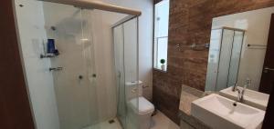 a bathroom with a shower and a toilet and a sink at Casa Vista Pontal in Ilhéus +25 photos
