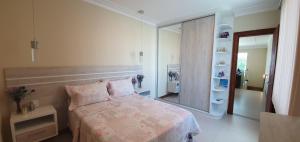a bedroom with a bed and a large mirror at Casa Vista Pontal in Ilhéus