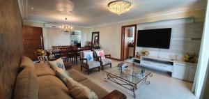 a living room with a couch and a dining room at Casa Vista Pontal in Ilhéus