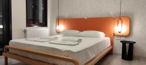 a bedroom with a large bed with an orange headboard at Super Stylish Studio & Bosphorus View in Ortaköy-8 in Istanbul