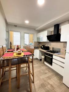 eine Küche mit einem Holztisch und einem Esszimmer in der Unterkunft Abilia Suite - À Proximité de l'Aéroport - Confort et Élégance in La Soukra