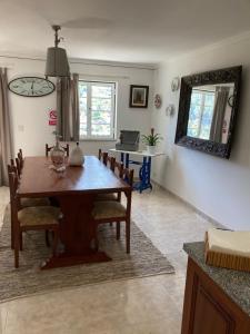 a dining room with a wooden table and chairs at A Casa da Rapariga de Cabelo Azul in Manteigas