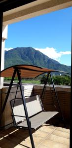 a hammock on a balcony with a view of a mountain at Yuncourt B&B in Jian