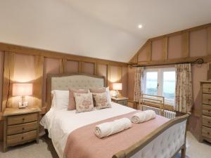 a bedroom with a large bed and a window at Lodge Cottage in Harwich
