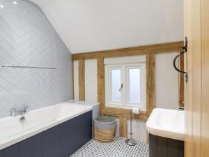 a bathroom with a tub and a sink at Lodge Cottage in Harwich +39 photos