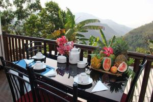 a table with a tray of fruit on a balcony at La Montagna in Ella