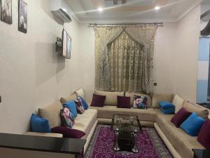 a living room with a couch and a table at AMAZIGH BIG Family APARTMENT in Meknès