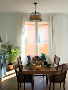 a dining room table and chairs with a table and a pendant light at Apartamento Duque33 in Cartagena