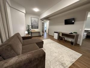 a living room with a couch and a desk at Condall Palace Hotel in Nova Prata