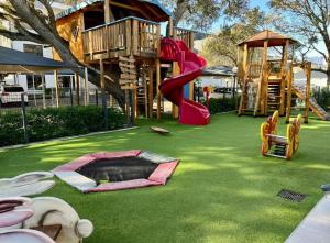 a park with a playground with a slide at Sunny Shores Hideaway in Cape Town