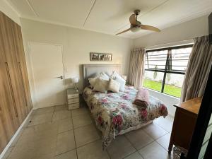 a bedroom with a bed and a window at Sunny Shores Hideaway in Cape Town +11 photos