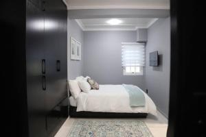 Ένα ή περισσότερα κρεβάτια σε δωμάτιο στο Trendy Cottage Hideaway