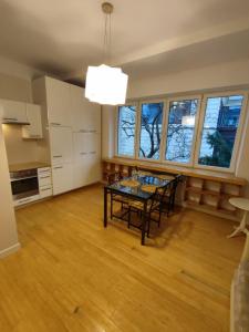 a kitchen and dining room with a table and chairs at Sulkowicka Apartment in Warsaw