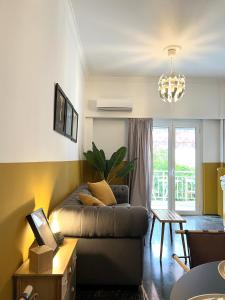 a living room with a couch and a table at Athenian Vintage Style 2 bdr apartment in Athens
