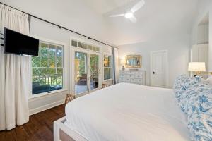 a bedroom with a large bed and a tv at 18 Ocean Green in Kiawah Island