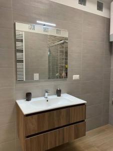La salle de bains est pourvue d'un lavabo et d'un miroir. dans l'établissement Dimora raggio di sole, à Mottola