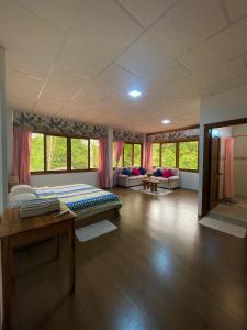 a large room with two beds and a table at La Casa De Eros in Ayampe