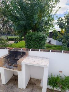 a white bench sitting next to a white wall at Las Casitas de Higuera in Higuera de la Sierra