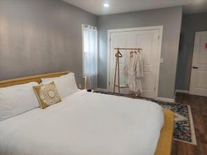 a bedroom with a large white bed and a closet at Welcome to the Anchor House!! in Asbury Park