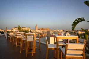 a row of tables and chairs on a roof at Hotel Inglaterra in Seville