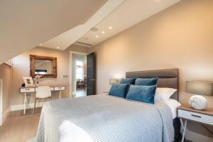 a bedroom with a large bed with blue pillows at Hampstead Luxury Flat-Hosted by Sweetstay in London