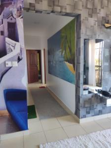 a living room with a wall with a mirror at 2BR Shanzu Serena in Mombasa