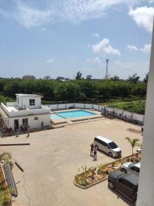 a view of a parking lot with a van and a pool at 2BR Shanzu Serena in Mombasa