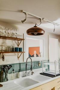 a kitchen with a sink and a mirror at Moonrise on Mill St. Inn- Carriage Haus in Nevada City