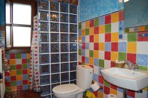 a bathroom with a toilet and a sink at Casa de Aldea La Llosa in Ribadedeva